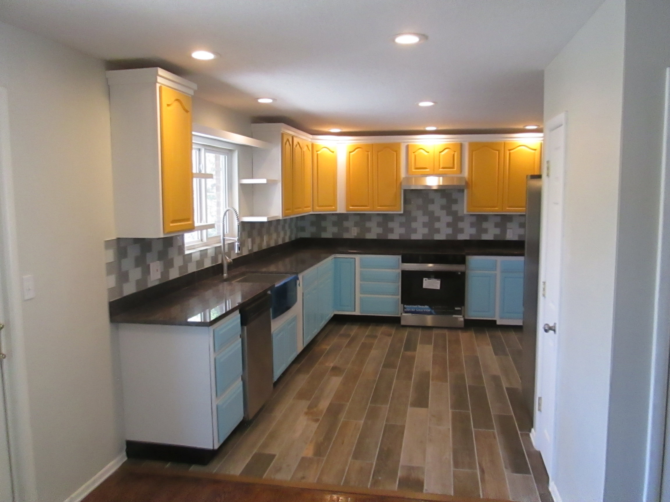 Kitchen featuring wood-finish flooring, recessed lighting, and a mosaic tile backsplash