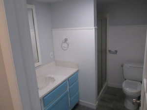 Bathroom vanity featuring a light-colored countertop, an undermount sink, and blue cabinet fronts