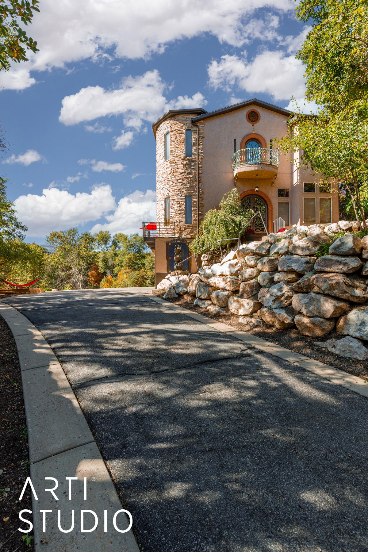 Stone-clad turret exterior with a stucco finish