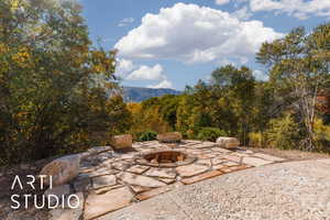 Outdoor flagstone patio featuring a built-in fire pit with brick interior and stone surround