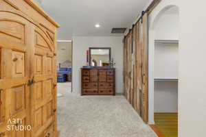 Reclaimed wood-finish barn door system with black hardware