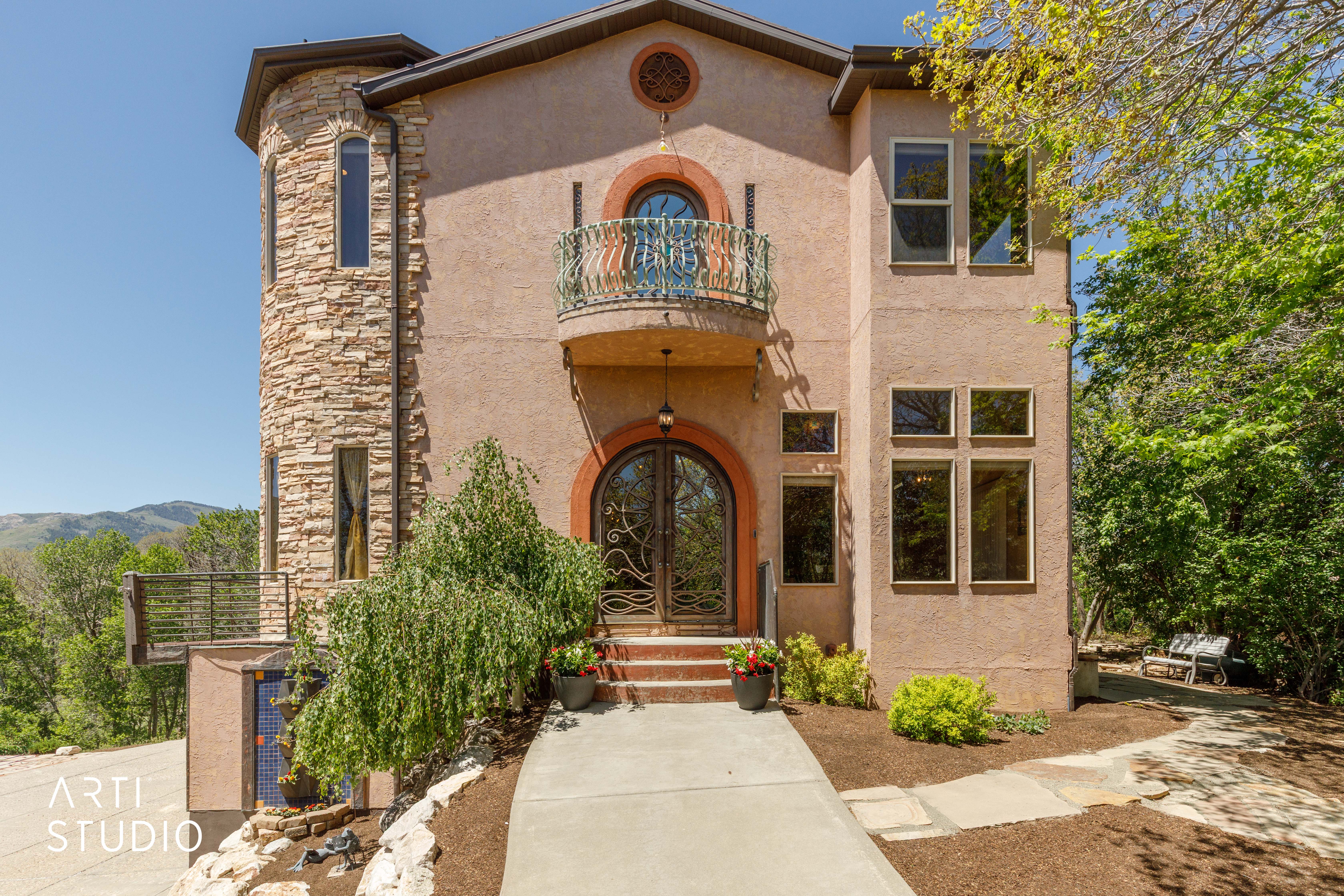 Stucco exterior with a stone-clad turret