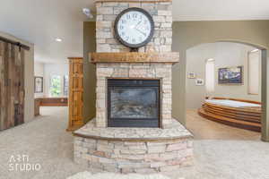 Stone-clad fireplace with a wood mantle and gas insert