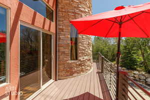 Exterior deck with wood-finish flooring and modern metal railings