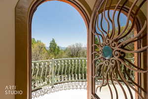 Arched doorway featuring a custom copper gate with a central turquoise accent