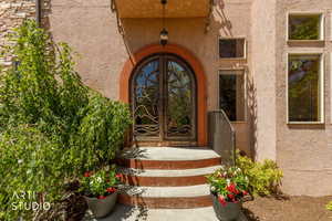 Arched double entry doors with decorative metalwork