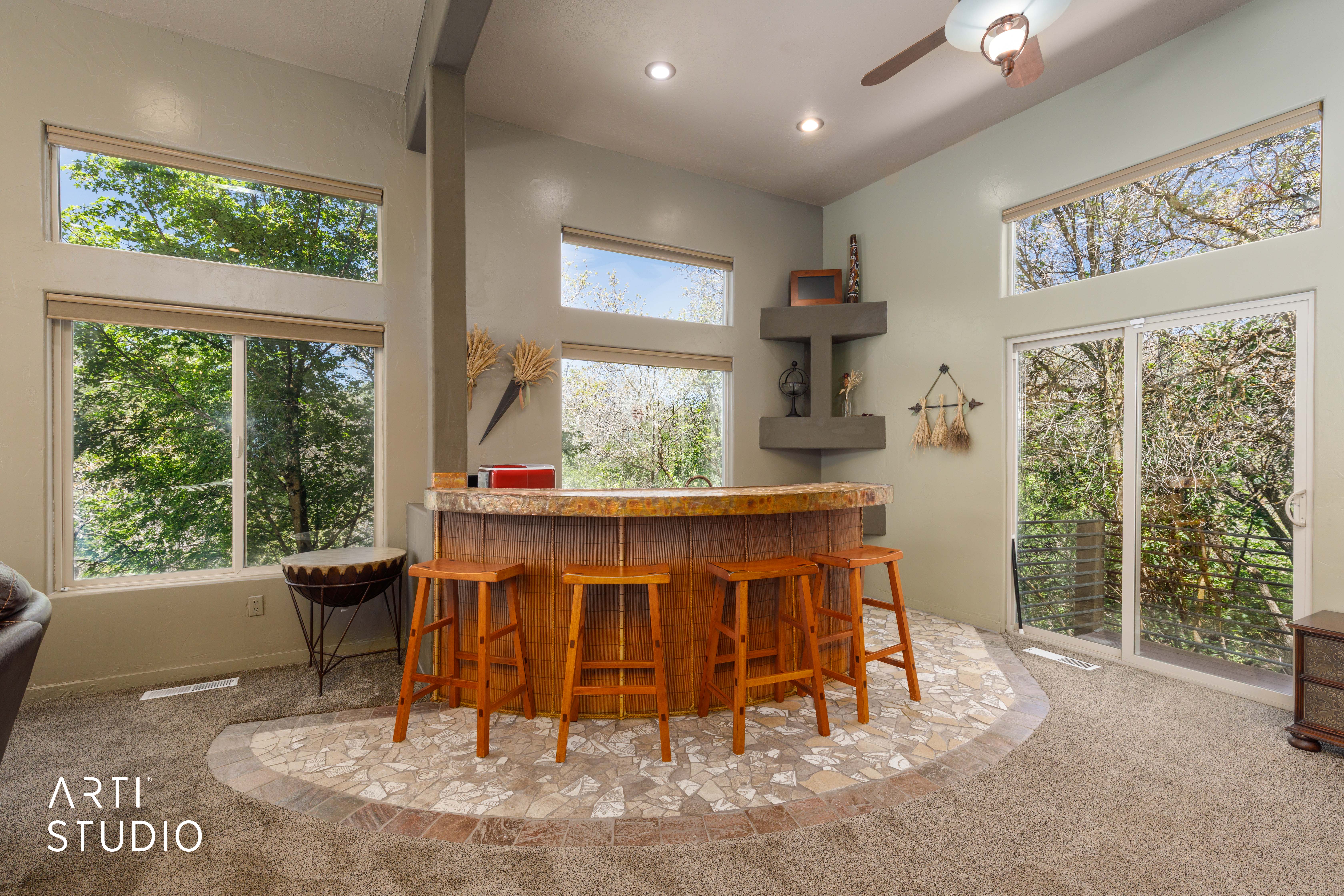 Built-in bar with stone countertop and mosaic tile flooring