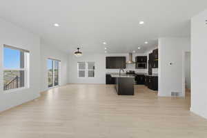 Expansive open-concept living area featuring light wood-finish flooring