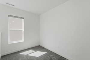 Bright room featuring neutral wall tones and a single window with a roller shade