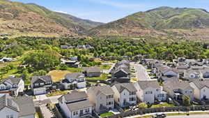 New construction properties nestled within a residential community, featuring consistent architectural styles and mountain scenery