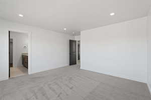 Bright room featuring light gray carpet flooring and white walls