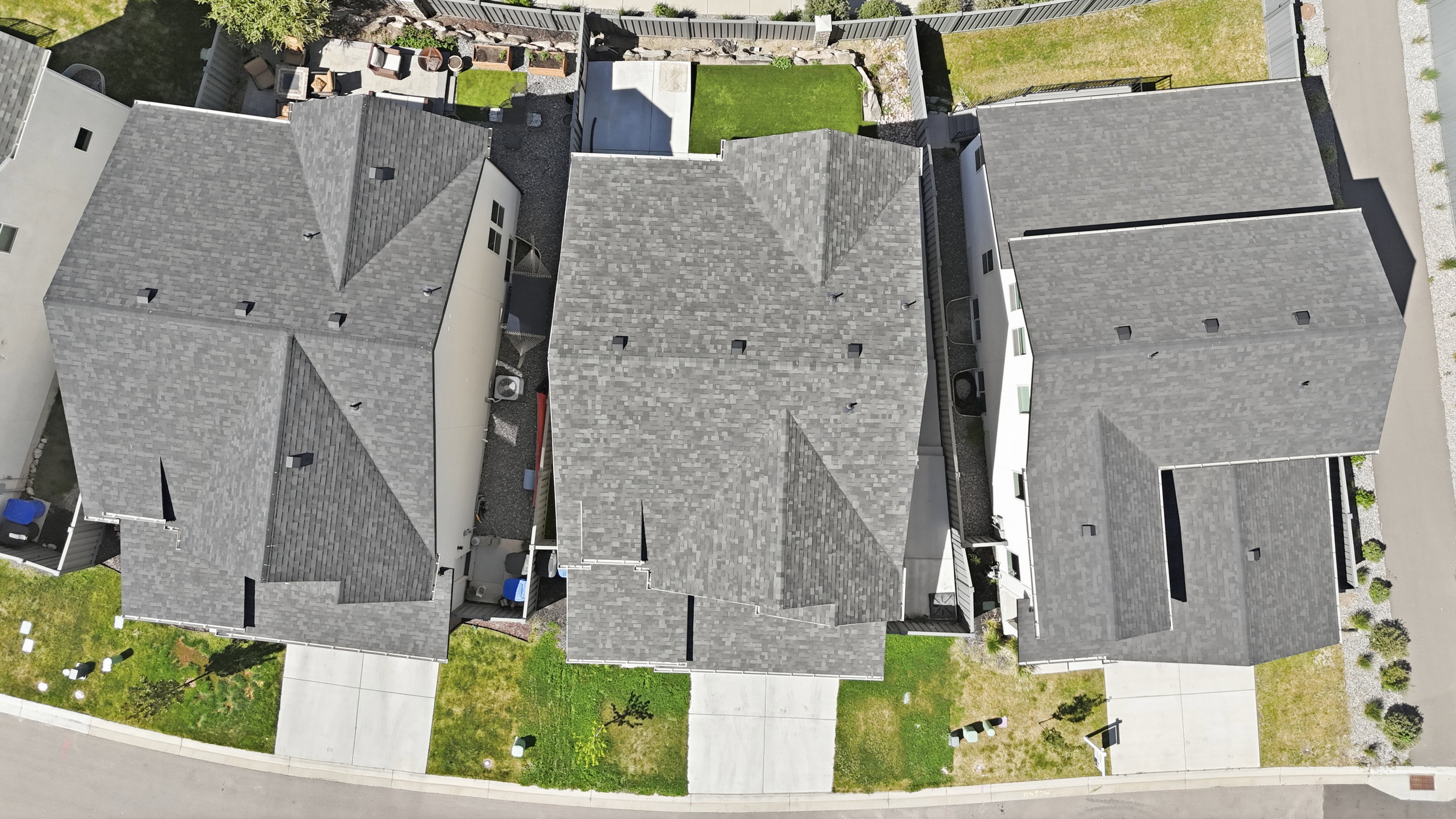 Aerial view of a residential property featuring a gray asphalt shingle roof