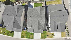 Aerial view of a residential property featuring a gray asphalt shingle roof