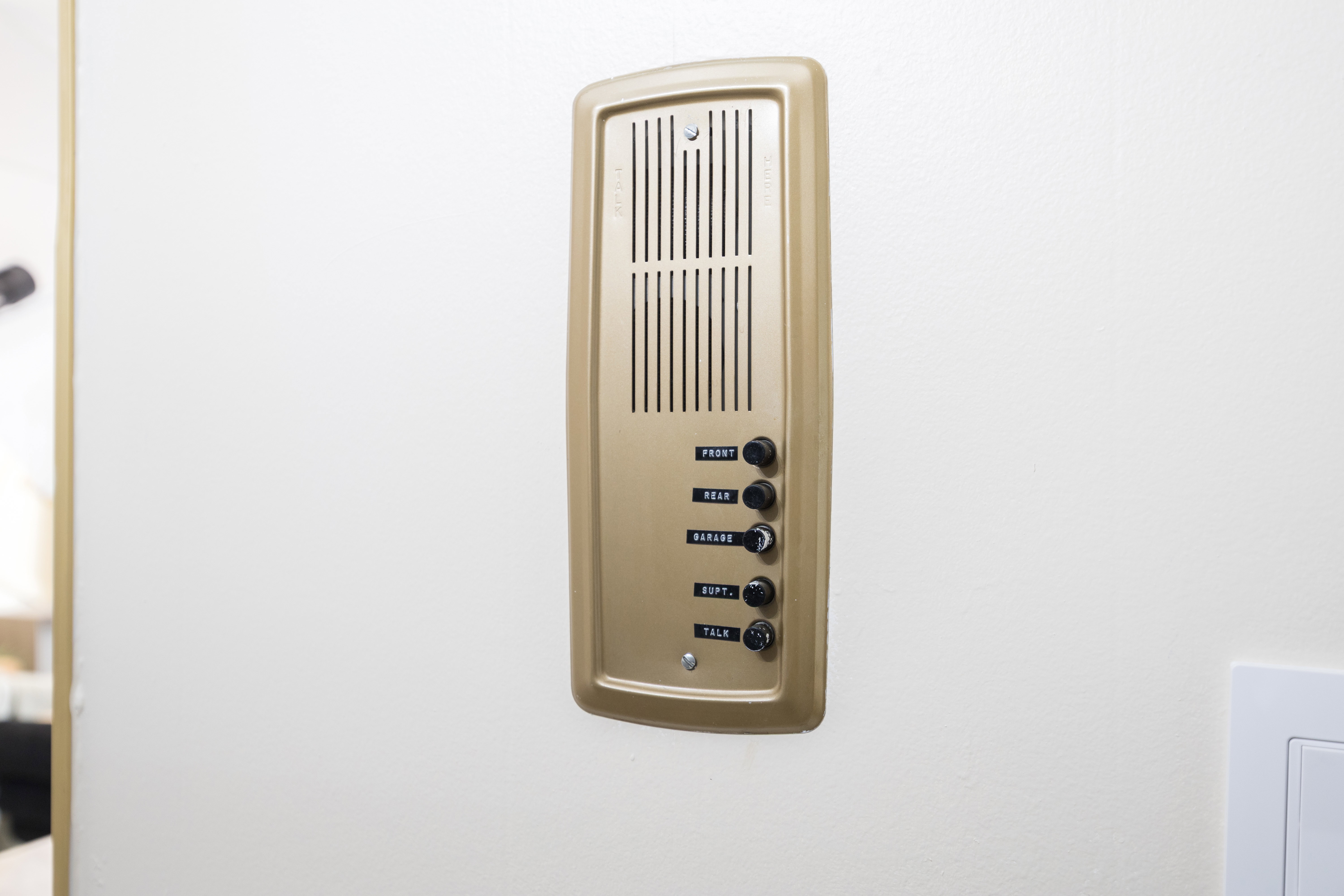 Vintage intercom system with a gold-tone finish