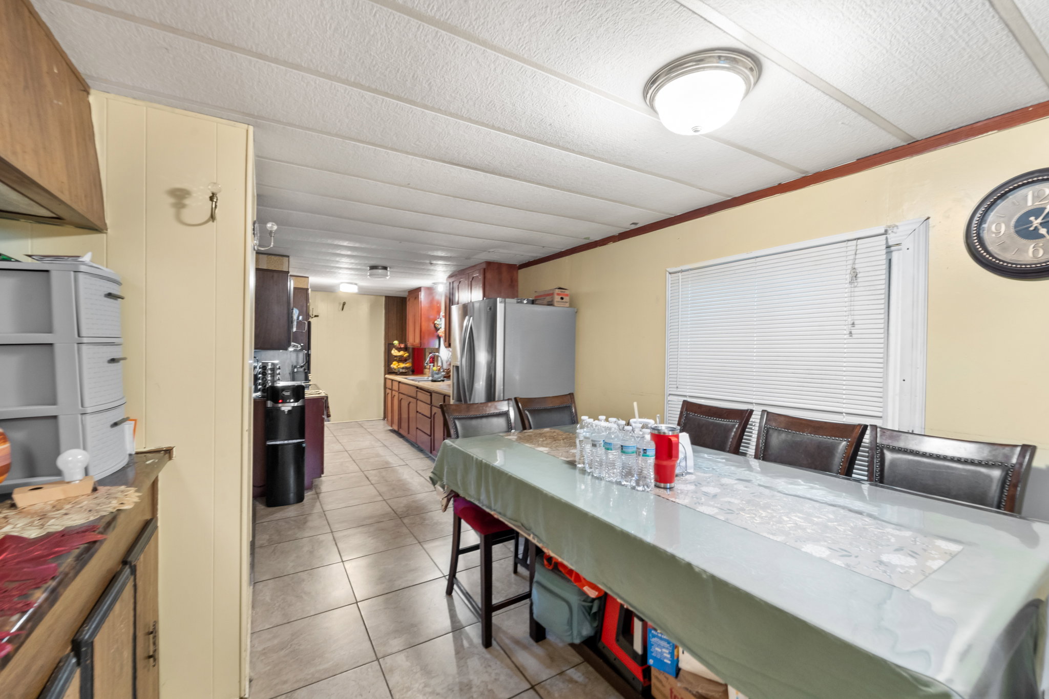 Dining area with a window featuring horizontal blinds