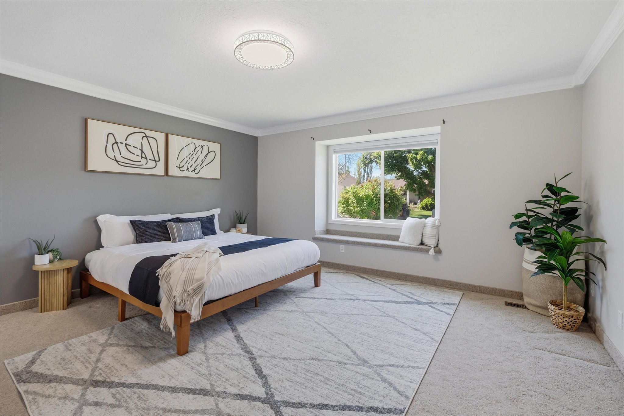 Spacious Primary Suite Bedroom featuring crown molding, a window with a built-in window seat, recessed lighting, and soft carpeting