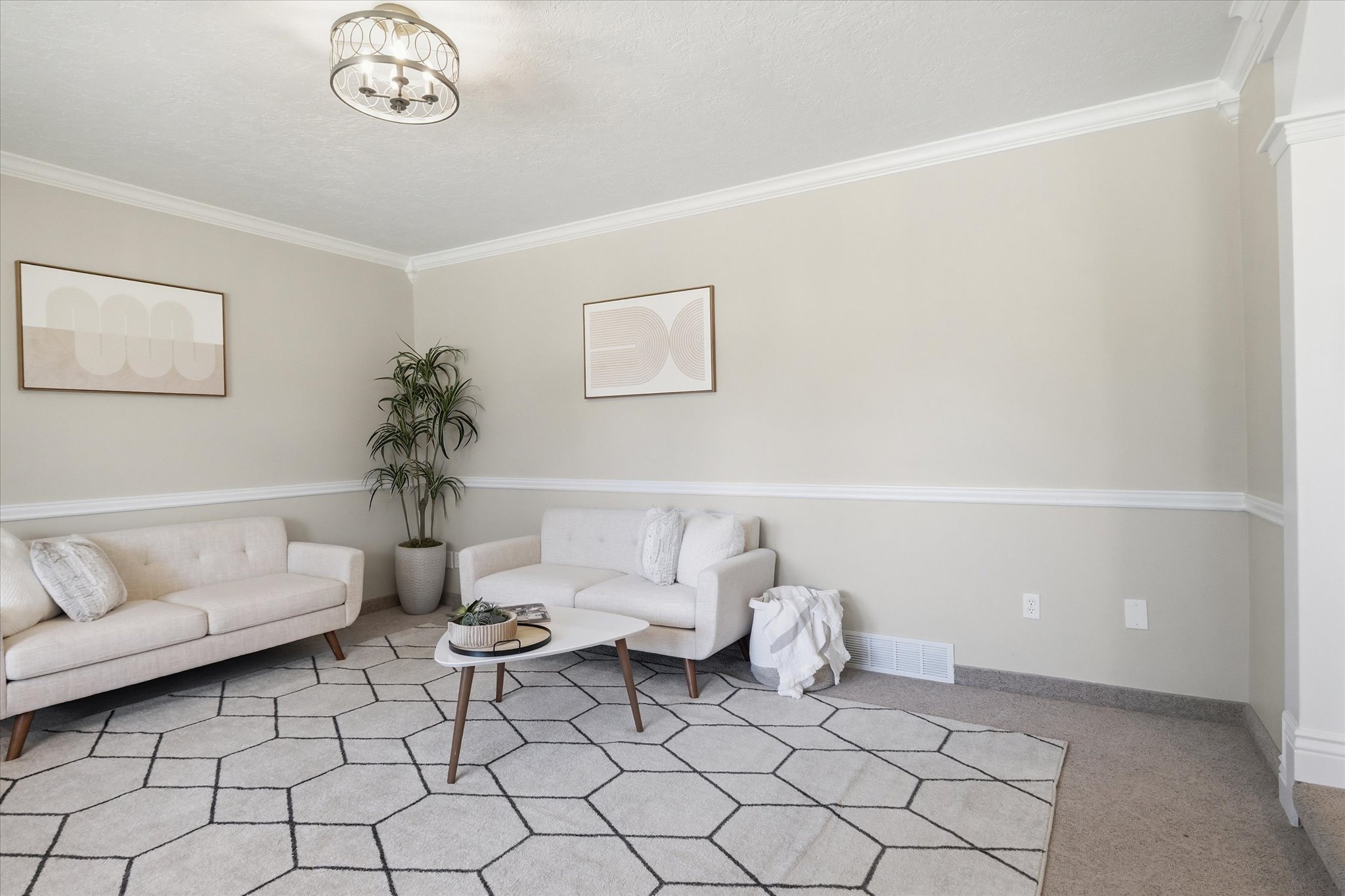 Neutral-toned family room with crown molding and chair rail detailing
