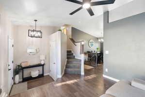 Entry foyer featuring wood-finish flooring and a modern linear chandelier