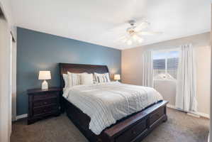 Carpeted room featuring a ceiling fan with integrated lighting, and a built-in wall niche