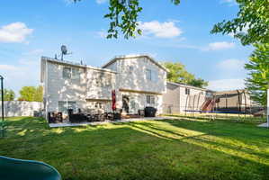 Expansive grassy yard with a concrete patio