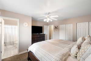 Spacious room featuring neutral wall tones, textured carpeting, and a ceiling fan with integrated lighting