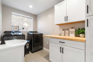Spacious laundry- room featuring light gray wall paint and tile flooring