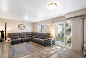 Spacious interior room featuring plush gray carpeting and neutral wall tones