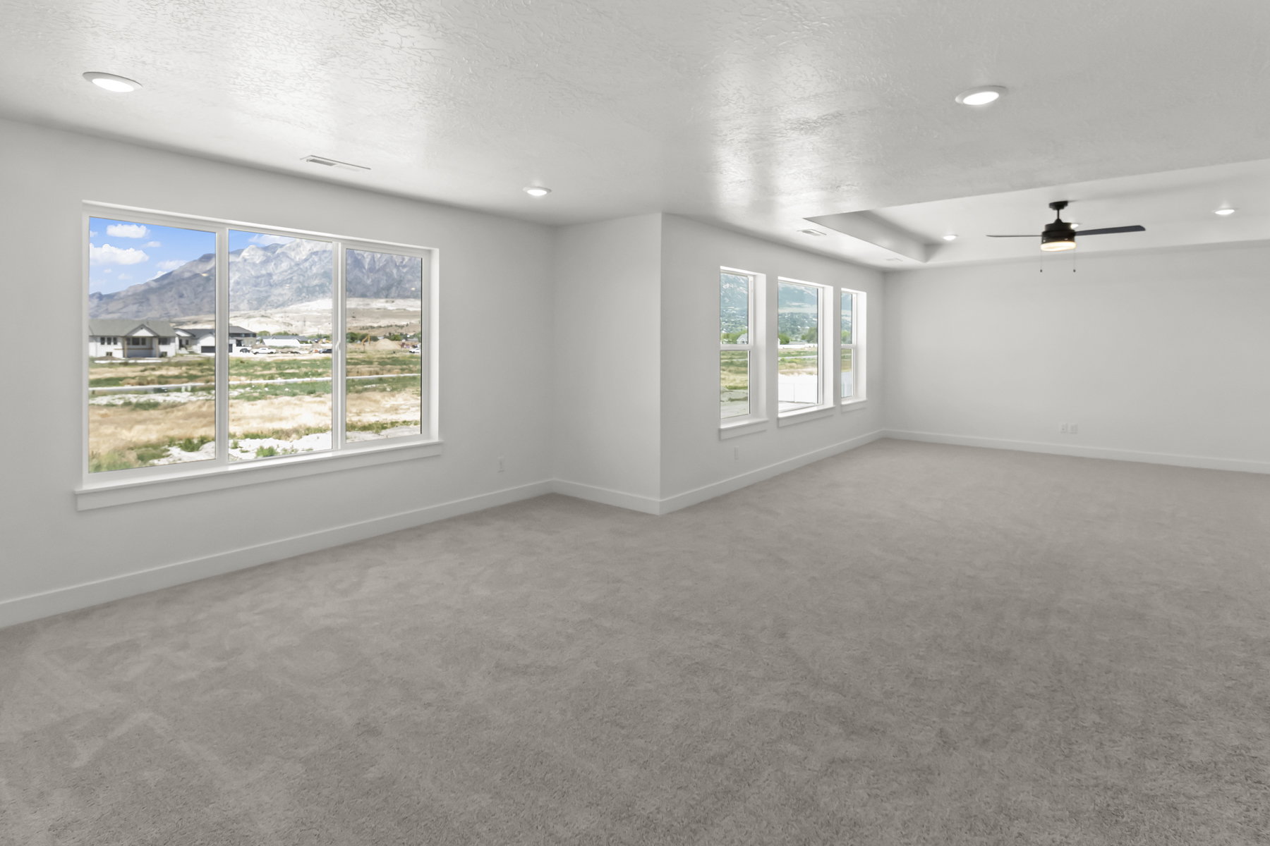 Expansive room featuring multiple windows and an amazing view of the mountains!