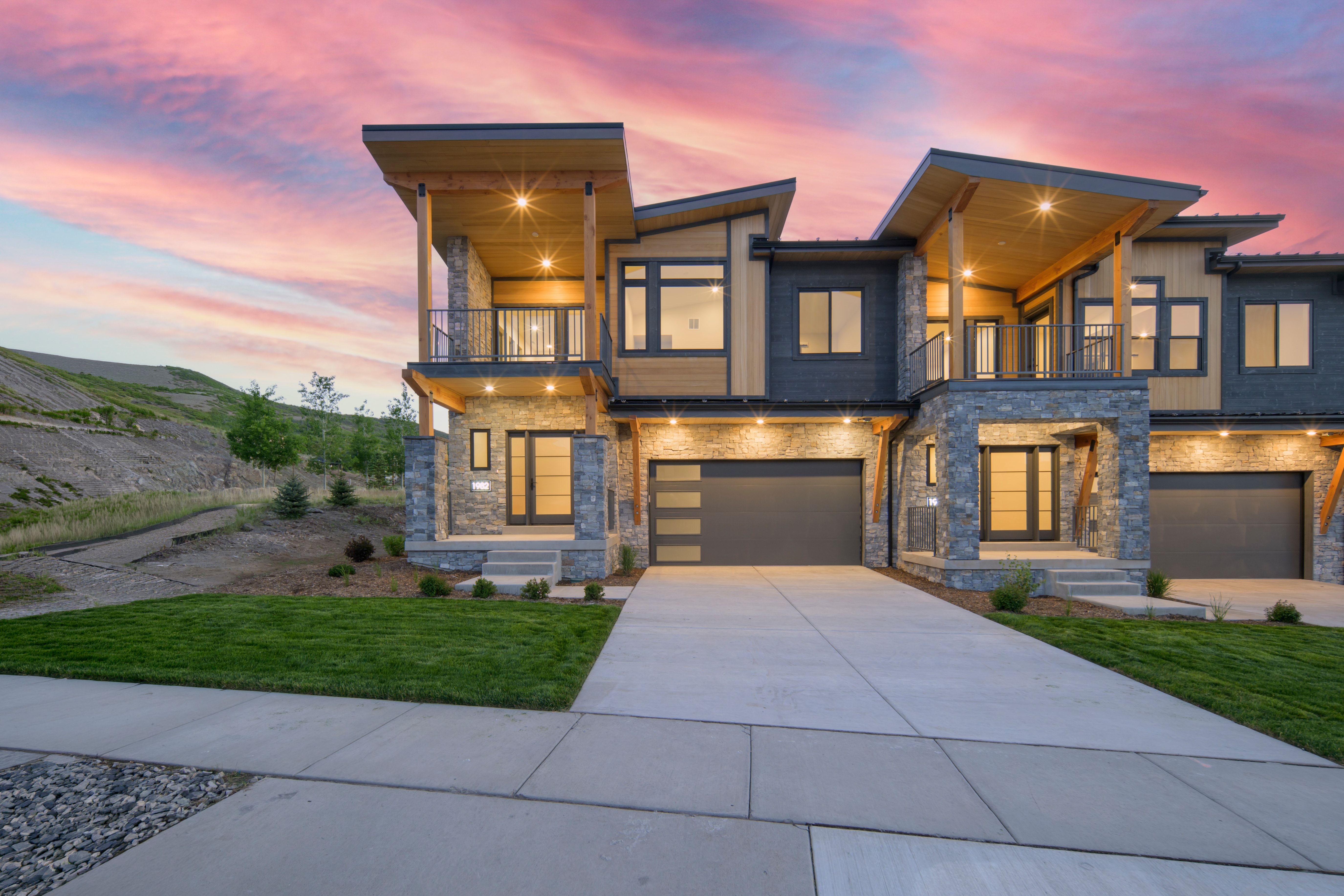 Contemporary architectural style featuring a multi-tone facade with stone and wood-look siding