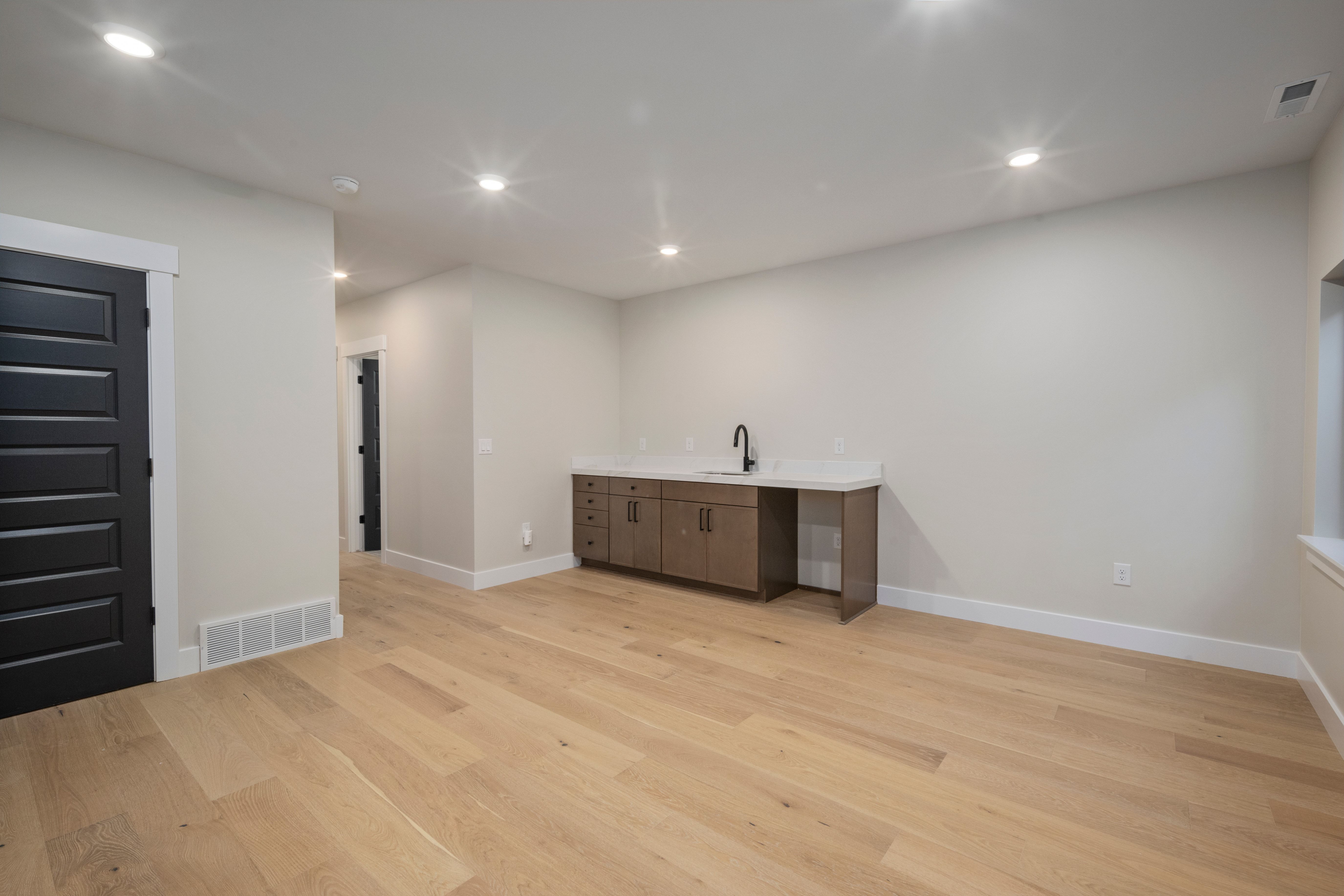 Light wood-finish flooring complements the neutral wall tones