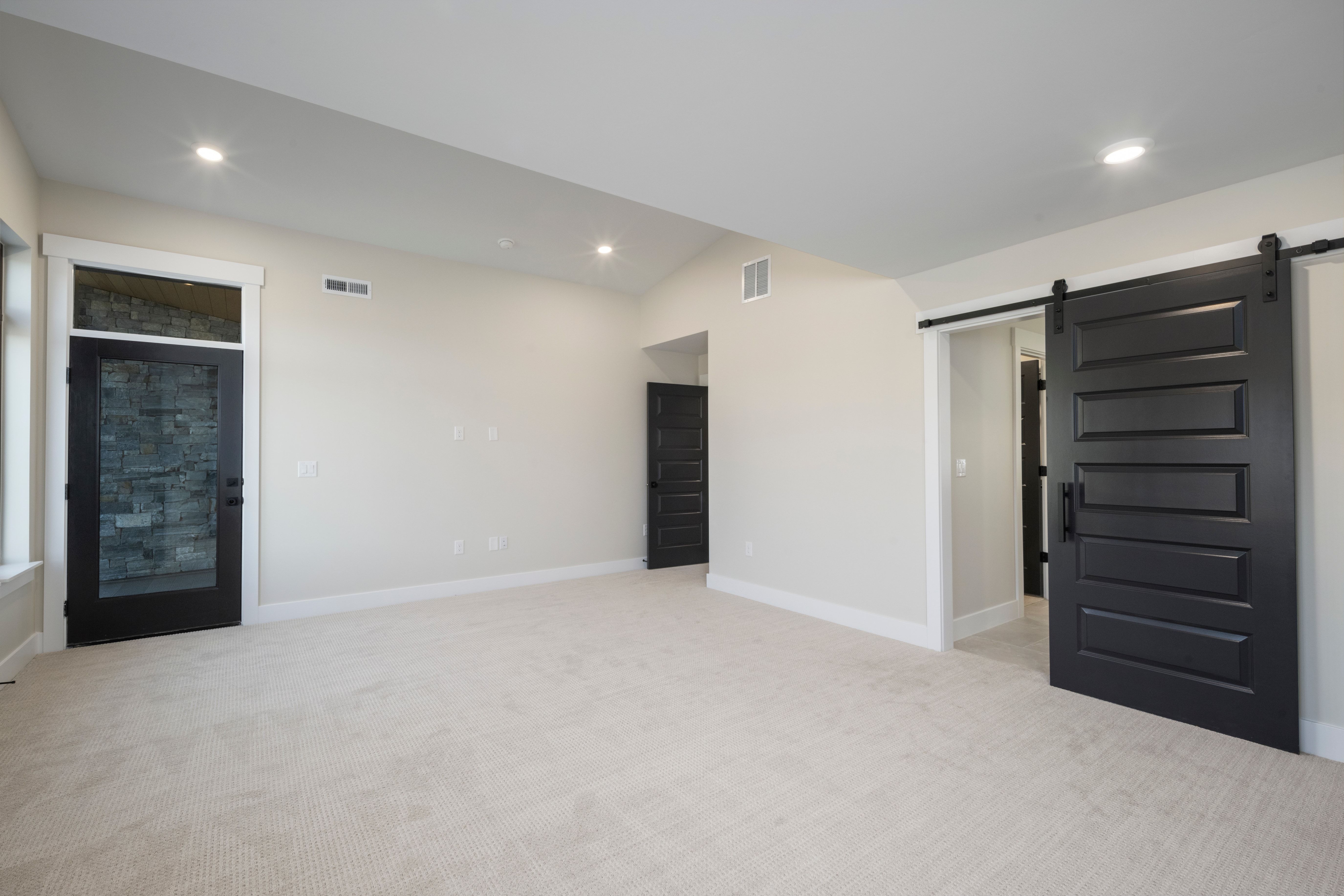 Spacious room featuring light-toned carpeting and neutral wall tones