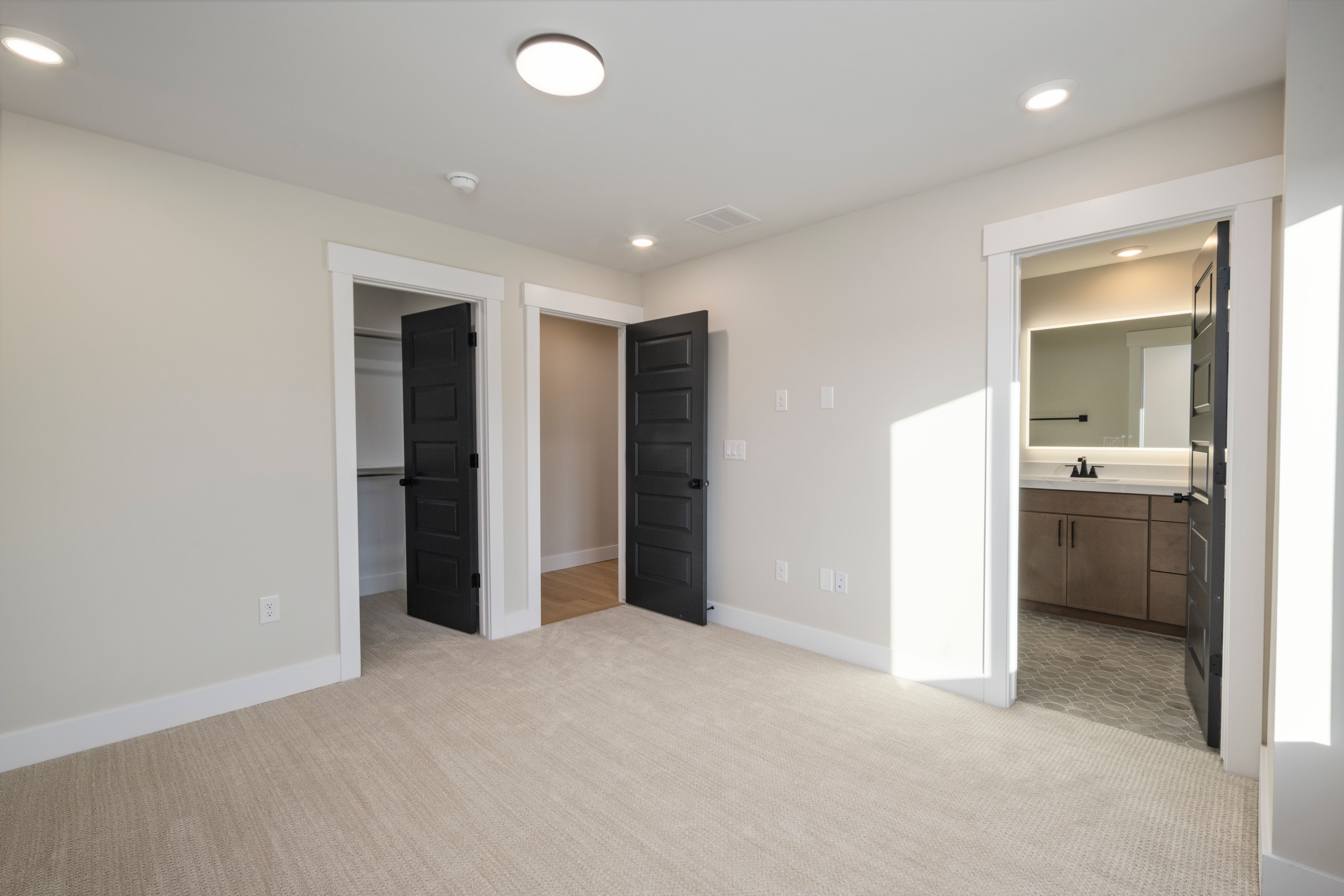 Carpeted bedroom with recessed lighting, white walls, and white trim