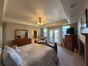 Recessed tray ceiling with crown molding and a ceiling fan