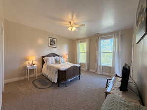 Spacious room featuring neutral wall tones, textured carpeting, and white baseboards
