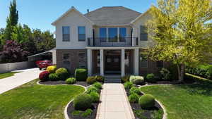 Two-story residence featuring a brick and stucco exterior
