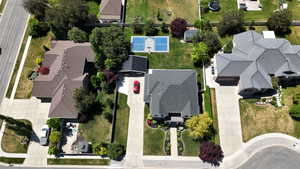 Contemporary multi-story residence with a dark shingle roof and an attached garage