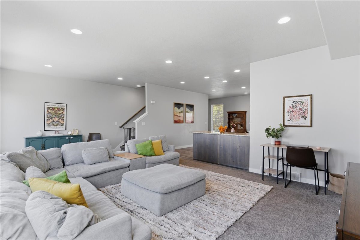 Open-concept living area featuring recessed lighting and light gray wall tones