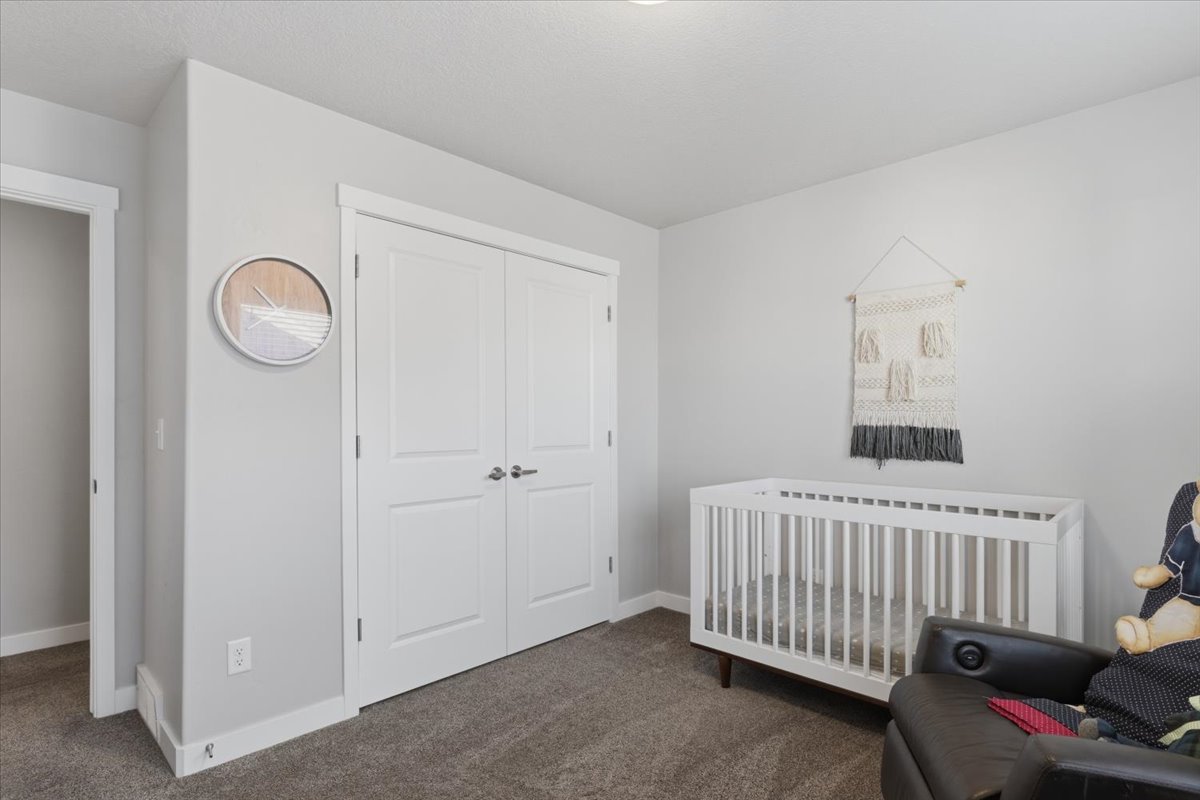 Room featuring light gray wall paint, carpeting, white baseboards, and white trim