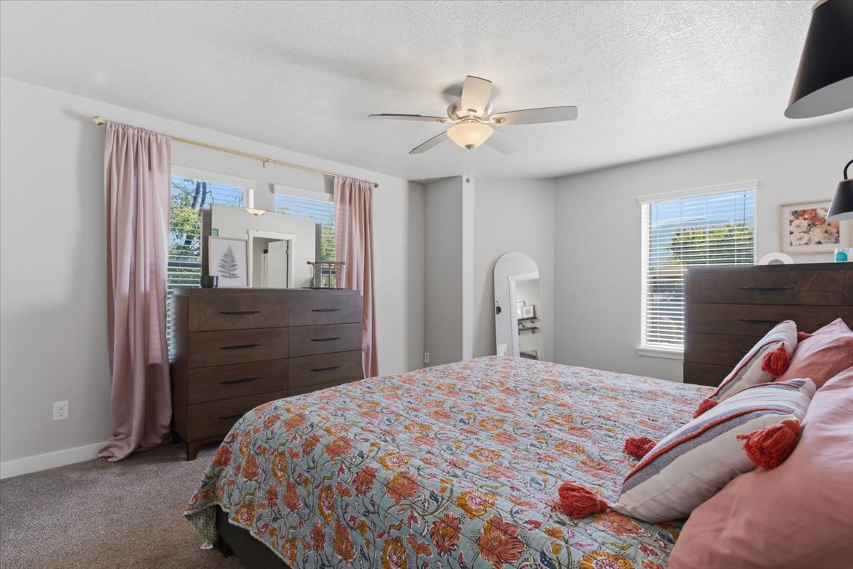 Spacious room featuring light gray walls and plush gray carpeting