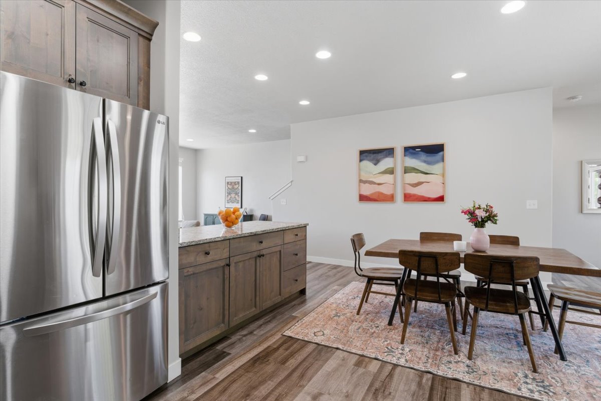 Open-concept living space with wood-finish flooring, recessed lighting, and light gray walls