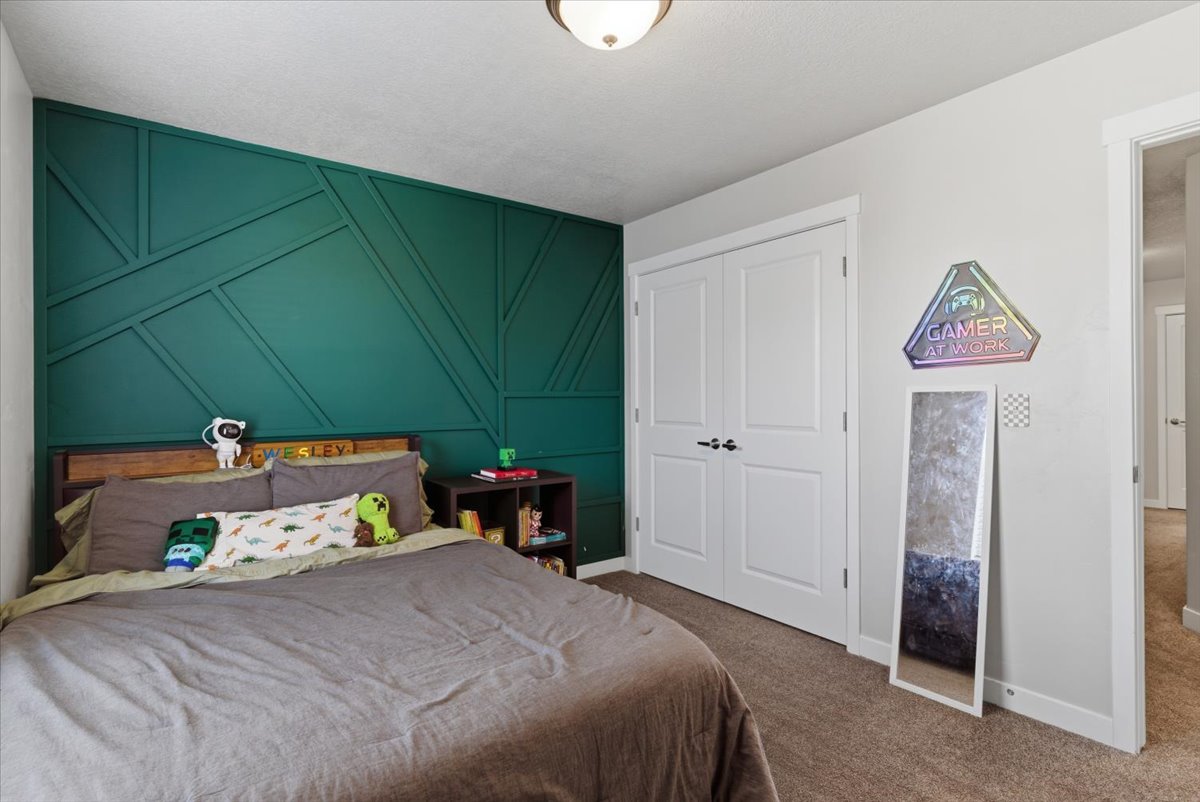 Accent wall featuring geometric paneling in a deep green hue