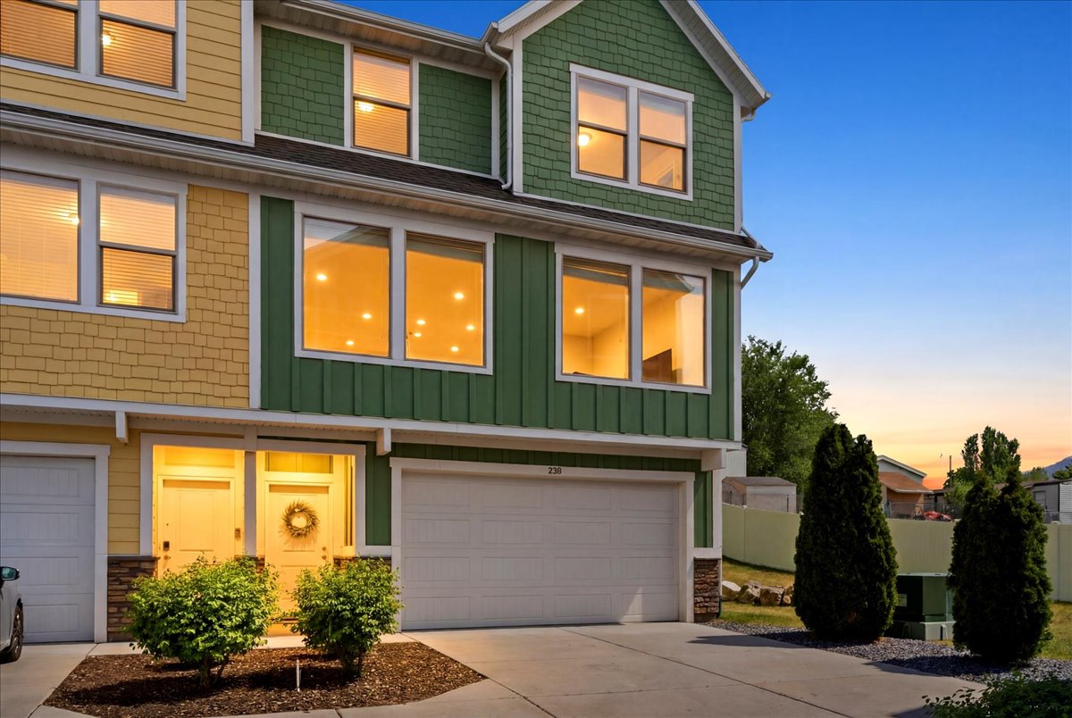 Multi-story townhome with a two-car garage and a paved driveway