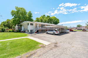 Multi-unit residential structure with a white exterior and a light-colored trim