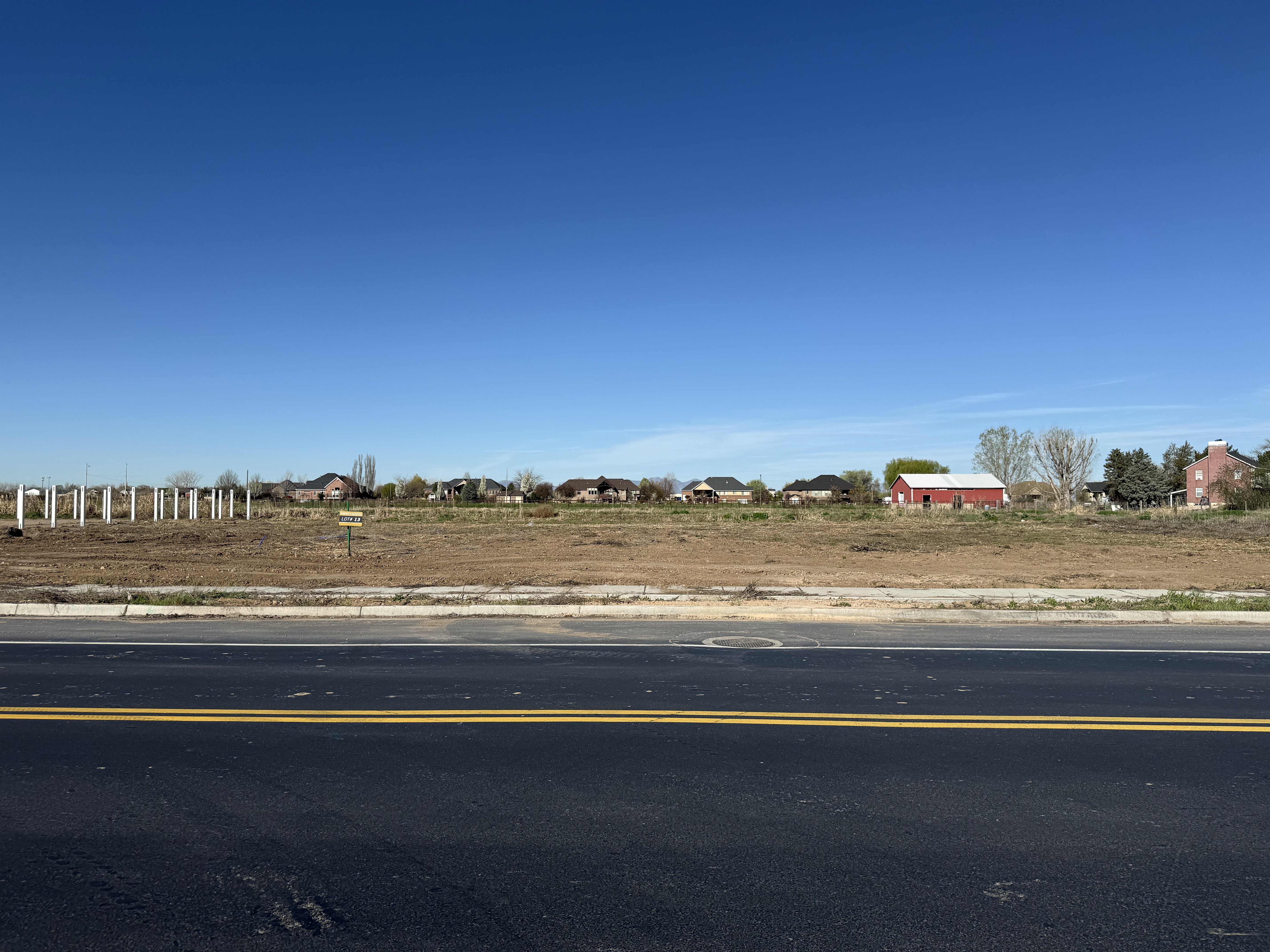 Expansive cleared lot with visible street frontage