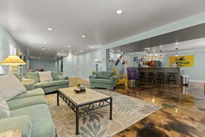 Expansive recreation room featuring a built-in bar with pendant lighting, a tile-finish bar front, and seating for four