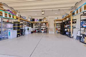 Spacious garage featuring a light-colored, speckled floor finish