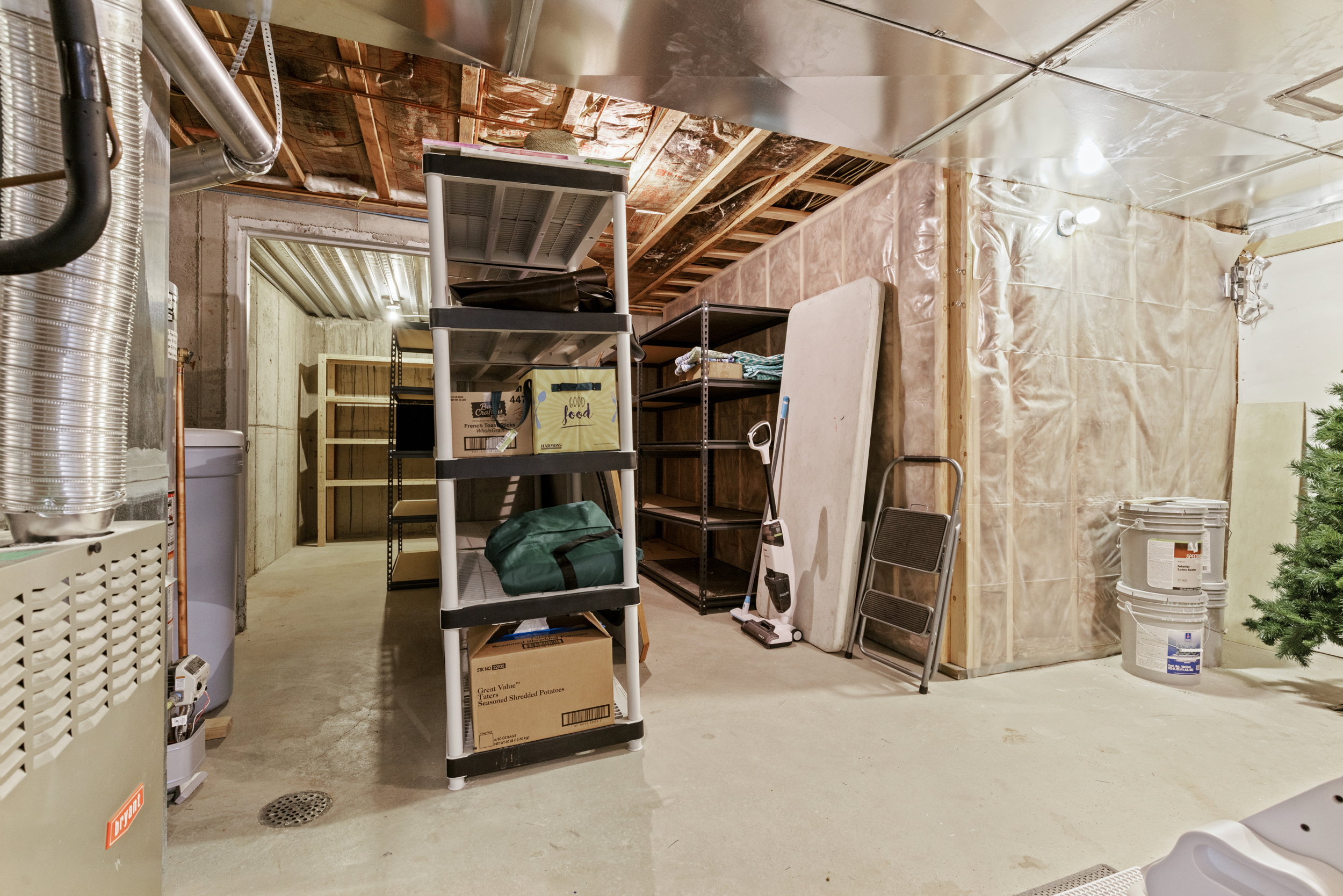 Unfinished basement featuring exposed ceiling joists and concrete flooring