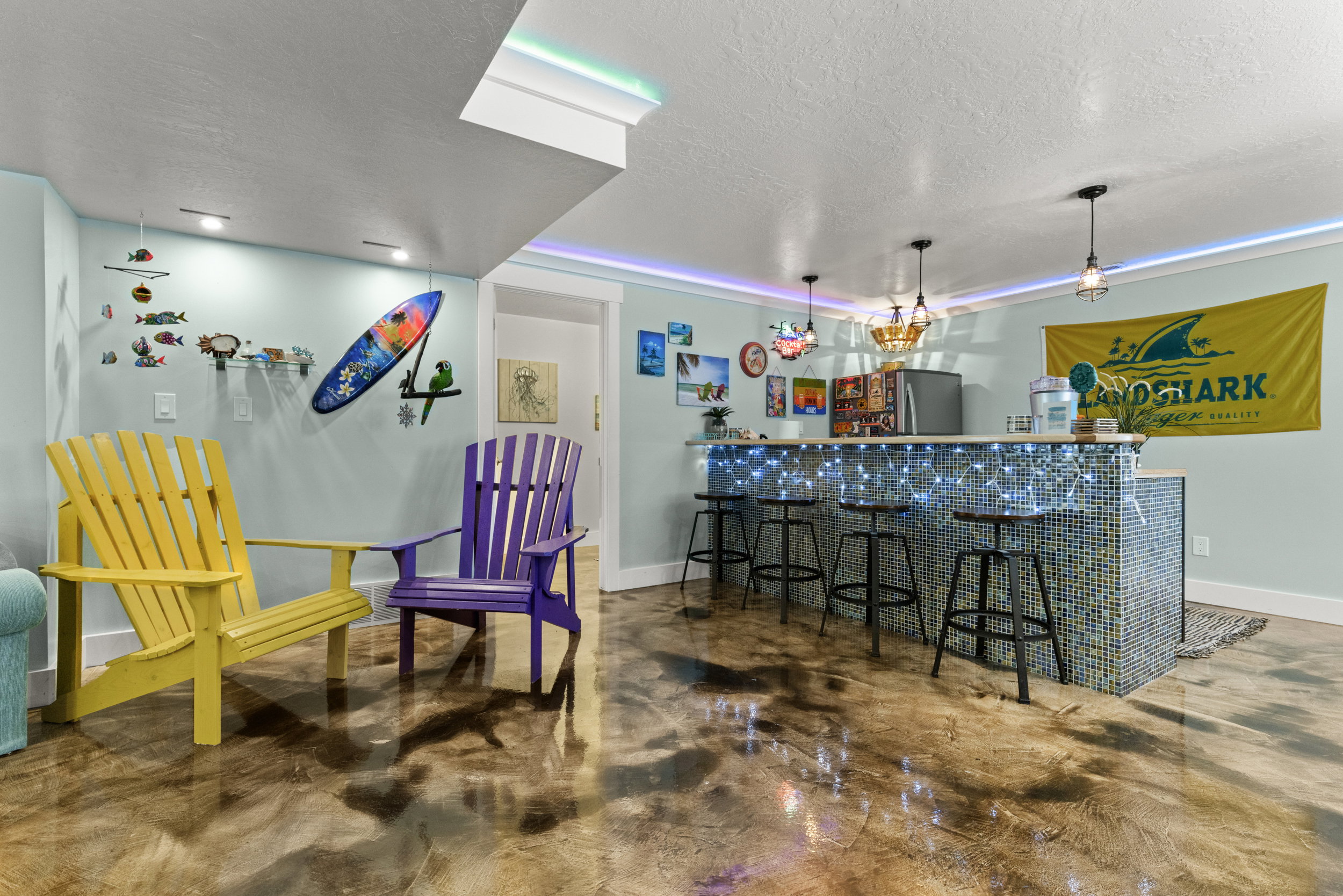 Recreational space featuring a built-in bar with mosaic tile finish and pendant lighting