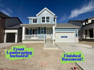 Contemporary two-story residence featuring a blue siding exterior with white trim accents and a covered front porch with white railings