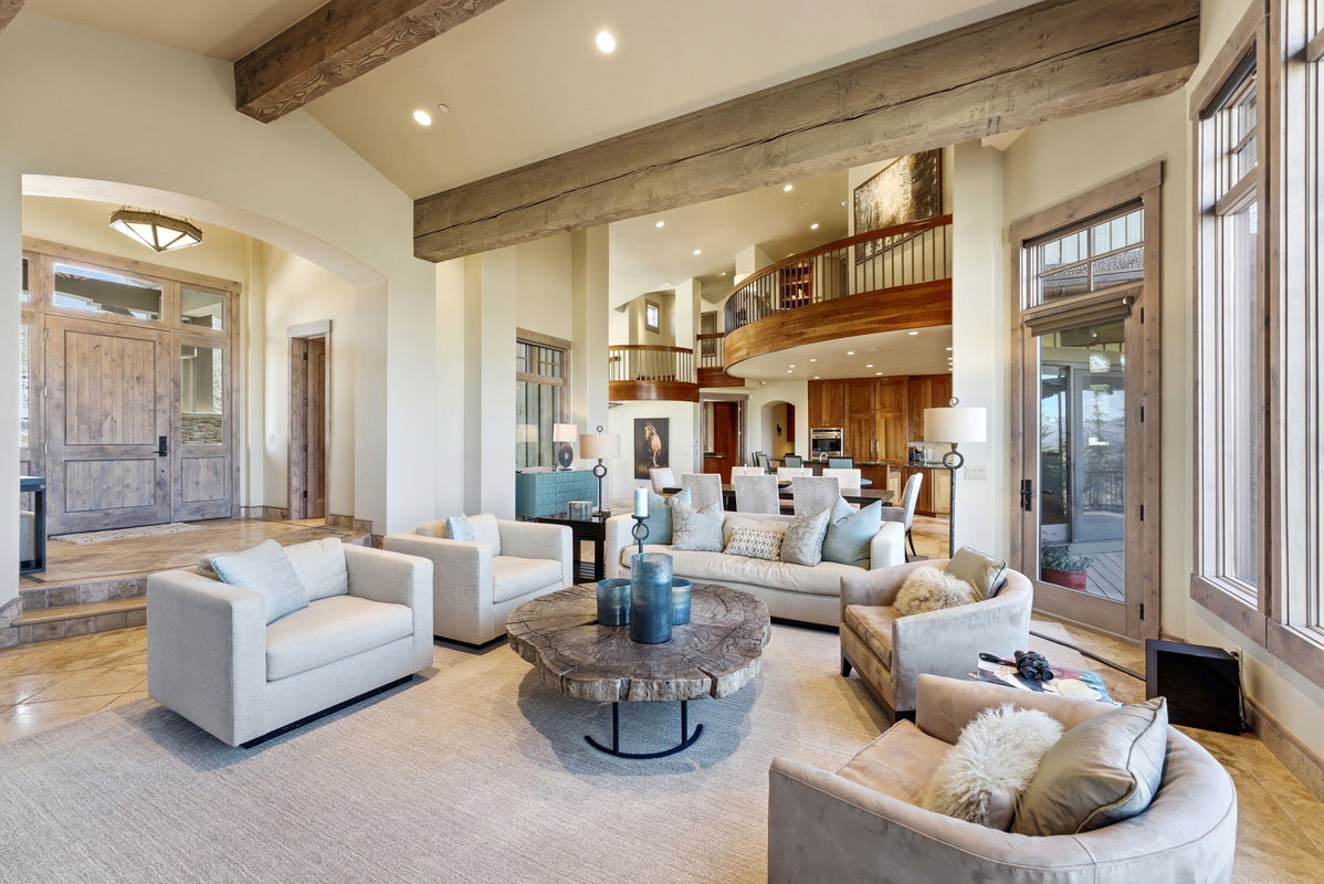 Spacious main living area featuring exposed wood beams and recessed lighting
